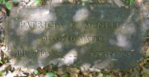 Photo of Patricia McNeely's gravestone. It reads "Beloved sister. July 9, 1956 to April 14, 1989."