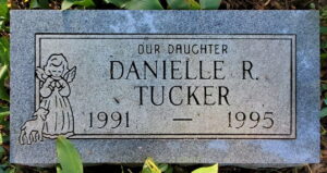 Gravestone decorated with an angel, reading, "Our daughter Danielle R. Tucker, 1991 - 1995."