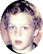 Photo of a young, blond, fair-skinned boy, cropped to an oval around his face.
