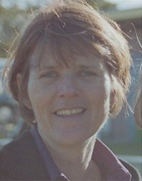 Photo of Janene Devine, a middle-aged white woman with short brown hair.