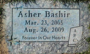 Gravestone reading Asher Bashir, March 23, 2005, August 26, 2009, forever in our hearts.