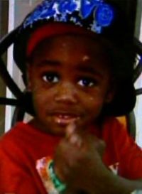 Photo of Teyshawn Young. He is a toddler with dark skin, wearing a red shirt and a blue hat.