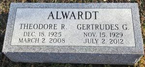 Photo of the gravestone of Gertrudes Alwardt. It reads, "Alwardt, Theodore R, Gertrudes G.", and gives birth and death dates for both.