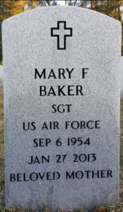White marble gravestone reading, Mary F Baker, Sgt, US Air Force, Sep 6 1954, Jan 27 2013, Beloved Mother.