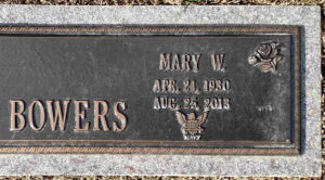Photo of a gravestone reading, Mary W Bowers, April 24, 1930 to August 25, 2013. It is decorated with two roses and the symbol of the US Navy.