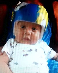 Photo of Noe Medina Jr., an infant with fair skin and chubby cheeks, wearing a blue helmet.
