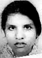 Black and white photo of a young woman with dark hair, dark eyes, and light skin.