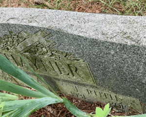Photo of a gravestone taken at a sharp angle; it reads, Hanyer, T. Ruth, 1931-2015.