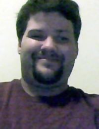 Photo of James Hill, an adult man with black hair and light skin. He is smiling. He has a short goatee and mustache.