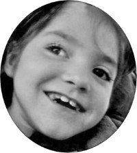 Photo of Jacee Sanner, in black and white. The photo is cropped so that just her face can be seen. Jacee is a young girl with fair skin. She is smiling and looking away to the side.