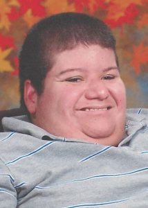 Photo of Jeffrey Kittredge II, a heavyset man with fair skin and short brown hair, smiling broadly.