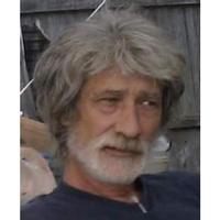 Photo of an older man with shaggy gray hair.