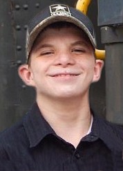 Photo of Jeffrey Franklin, a teenage boy wearing a baseball cap. His ears stick out and his skin is fair. He is smiling.