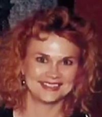 Photo of Susan Winters. She is a woman with pale skin and curly strawberry-blonde hair.