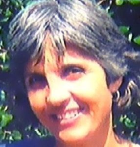 Photo of Annette Bouwer, a middle-aged woman with light, tanned skin and short, silver-gray hair.