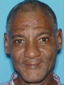 Photo of Pernell Robinson, a man with medium-brown skin and dark brown eyes. His graying dark hair is cut very short. He has a stubbly mustache and is smiling slightly.
