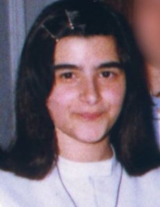 Photo of Paolo Manchisi. She is a teenage girl with light skin and black hair held back with two bobby pins. She is wearing a white blouse and necklace.