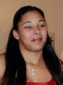 Photo of Jhalandia Butler, a young woman with long dark-brown hair and tan skin, wearing a red tank top.