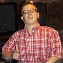 Photo of Judson Duncan, a young man wearing horn-rimmed glasses and a flannel shirt. He has fair skin and brown hair, and is making a thumbs-up gesture.