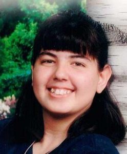 Photo of Courtney Turney, a young woman with dark-brown hair and tan skin. She is smiling for the camera.