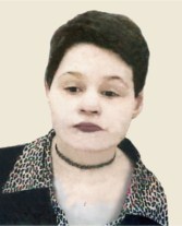 Photo of Andrea Bartlett, a young woman with very pale skin and red lips, her hair in a boy cut, wearing a choker and jacket with an animal print collar.