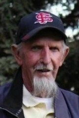 Photo of Chet Scharnick, an older man wearing a Cardinals baseball cap, sporting a wispy white goatee and mustache.