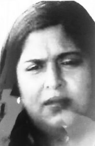 Black and white photo of a woman with straight, dark hair and a puzzled expression on her face.