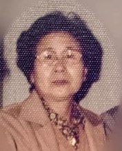 Photo of an older Japanese woman wearing glasses and a blouse.