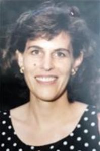 Portrait of a middle-aged, short-haired woman in a polka-dot dress.