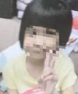 Photo of a toddler girl with dark hair and light skin, face blurred to obscure her identity.