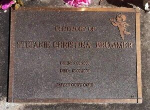 A gravestone reading, "In memory of Stefanie Cristina Brummer, born 2-08-2002, died 18-09-2005. Safe in God's care."