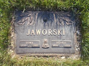 Photo of a gravestone that reads Jaworski, Sophie, 1920 to 2004. The stone is decorated with sheaves of wheat and an icon of a woman with a halo.