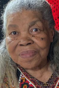 Photo of an older African American woman with light-brown skin and frizzy gray hair.