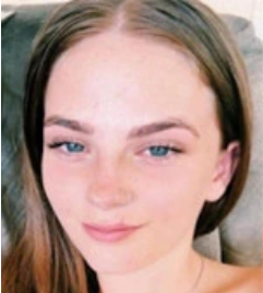 Photo of a fair-skinned girl with light-blue eyes and straight, brown hair.
