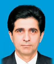 ID photo of a man with light skin and dark hair, dressed in a suit. His expression is serious.